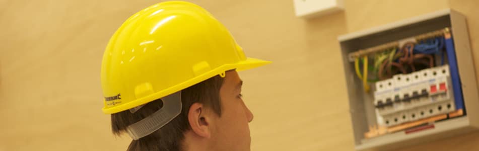 Male looking at fuse box.